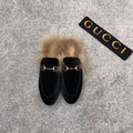 Black velvet loafer slide with beige faux fur trim and gold-tone ring hardware