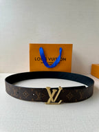 Dark brown monogram belt with gold buckle and textured edge