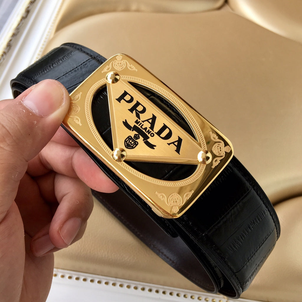 Black leather belt with gold Prada buckle, held in hand for detail