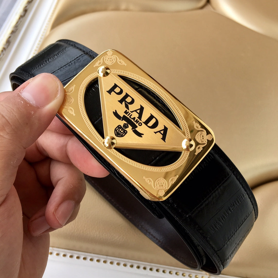 Black leather belt with gold Prada buckle, held in hand for detail