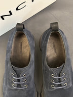 Navy suede shoes showing interior lining and lace-up eyelets detail