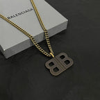 Balenciaga BB logo pendant necklace with gold chain and studded BB charm