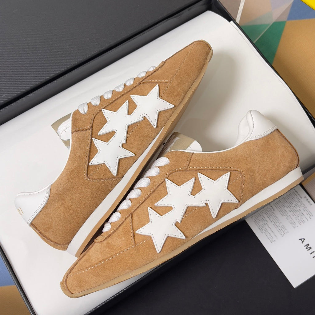 Tan suede sneakers with white star patches and white lace-up uppers