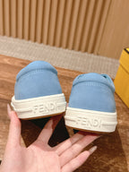 Light blue sneakers with FENDI logo on off-white heel tabs.