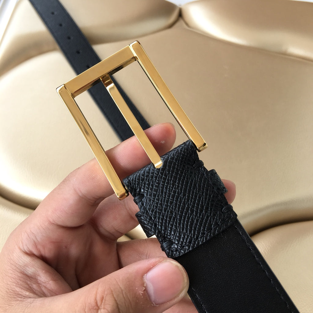 Dark leather belt with gold-tone rectangular buckle and textured strap panel
