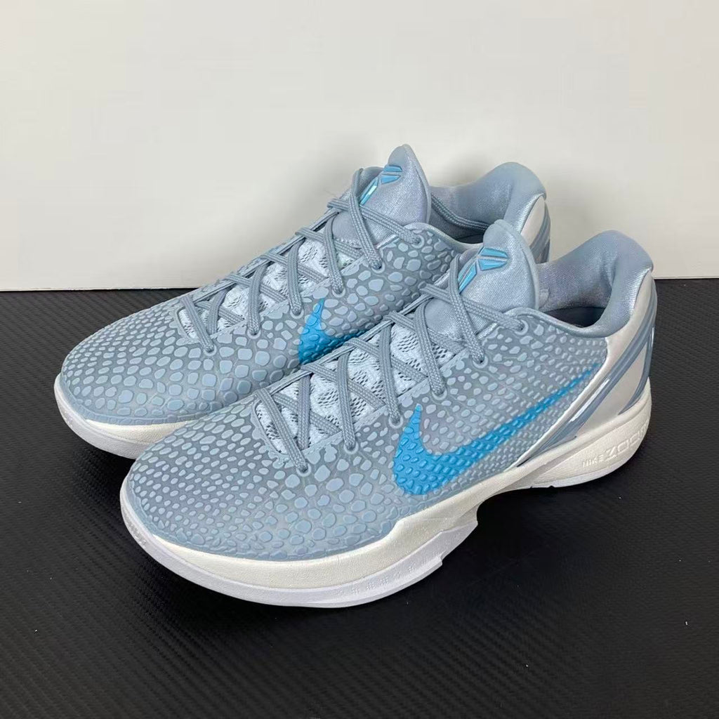 Light blue and gray basketball shoes with blue swoosh, lace-up, white rubber sole.