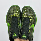 Pair of black and green basketball shoes with textured upper and black laces.