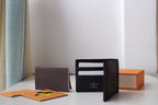 Louis Vuitton small black textured leather card pouch open, showing interior card holders