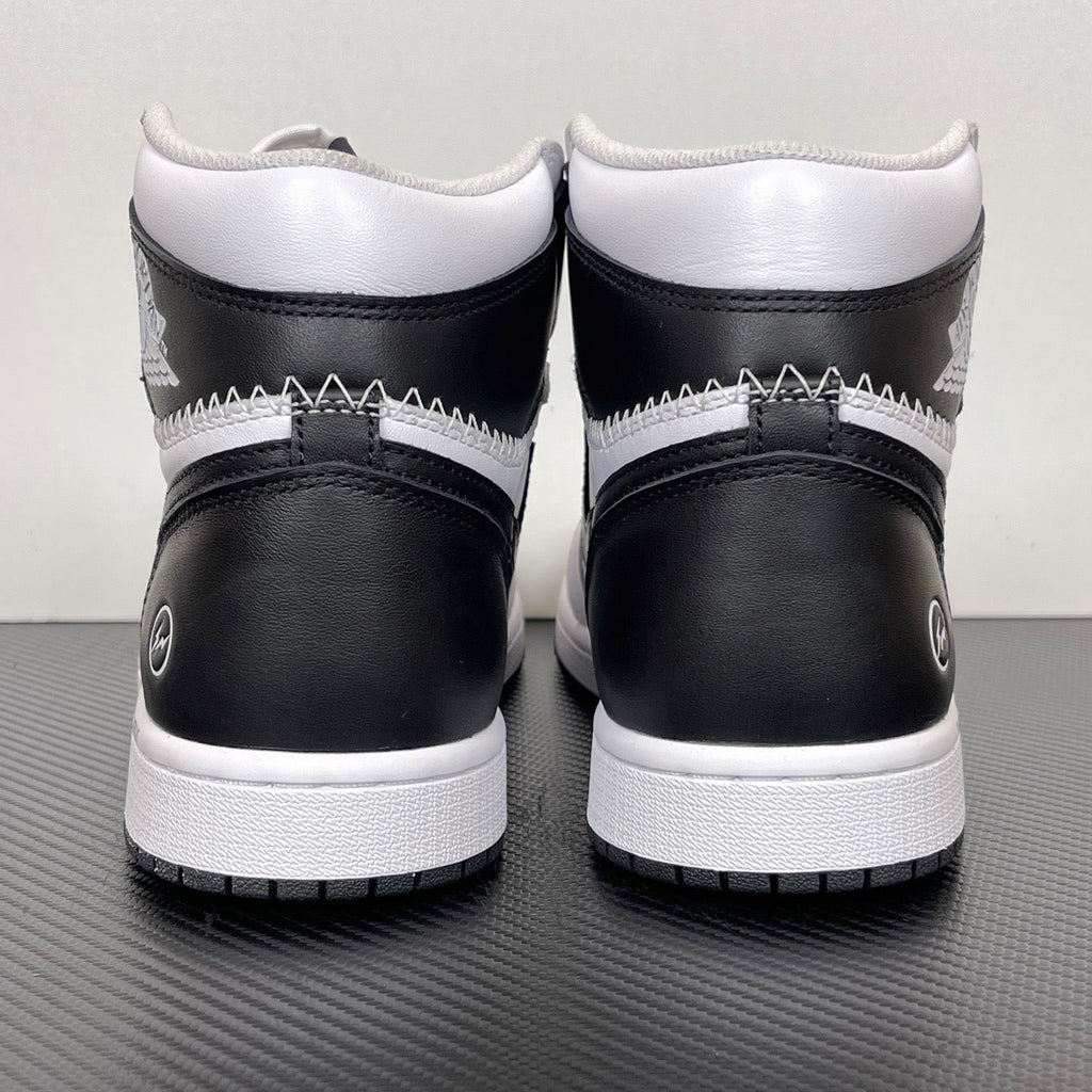 Pair of white and black high-top sneakers with black heel panels and white midsole