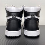 Pair of white and black high-top sneakers with black heel panels and white midsole