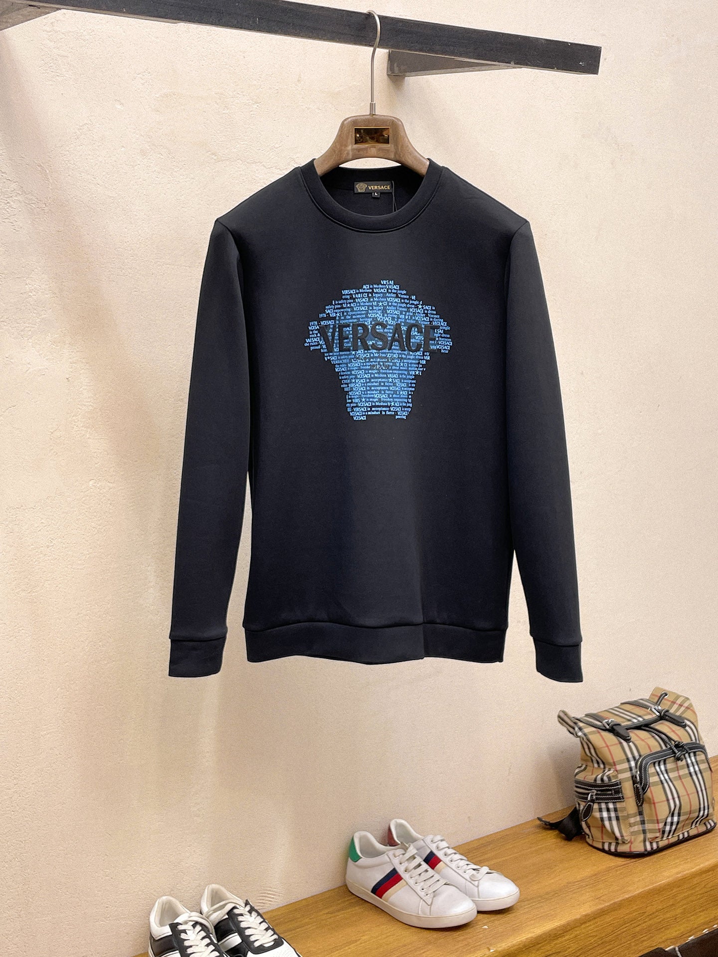 Crewneck sweatshirt in dark navy with Versace blue graphic logo on chest.