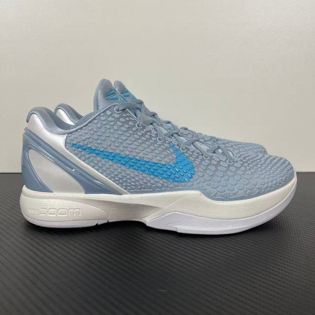 Light blue and gray basketball shoes with white sole, blue swoosh, lace-up.