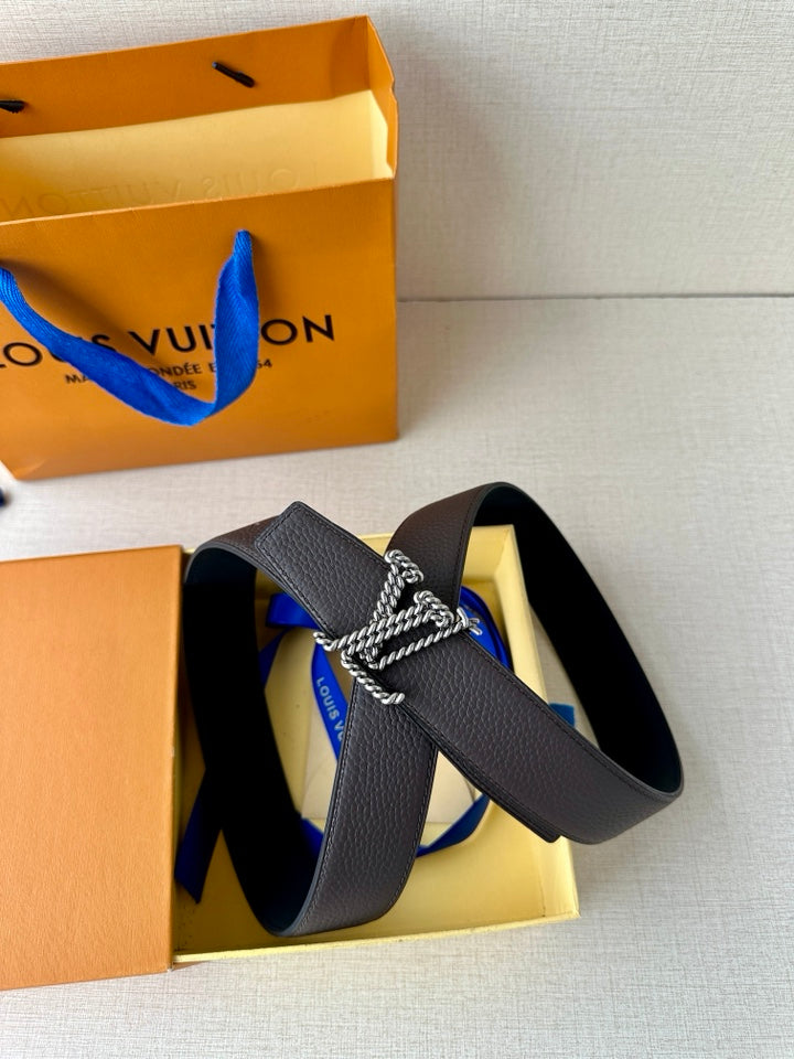 Louis Vuitton belt in dark leather with prominent gold-tone chain buckle