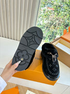 Louis Vuitton unisex loafers showing outsole tread on one shoe with black velvet upper