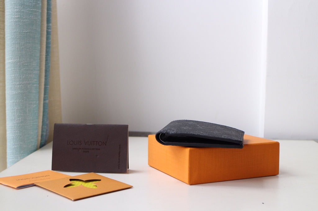 Louis Vuitton small bag, black leather pouch with dark strap