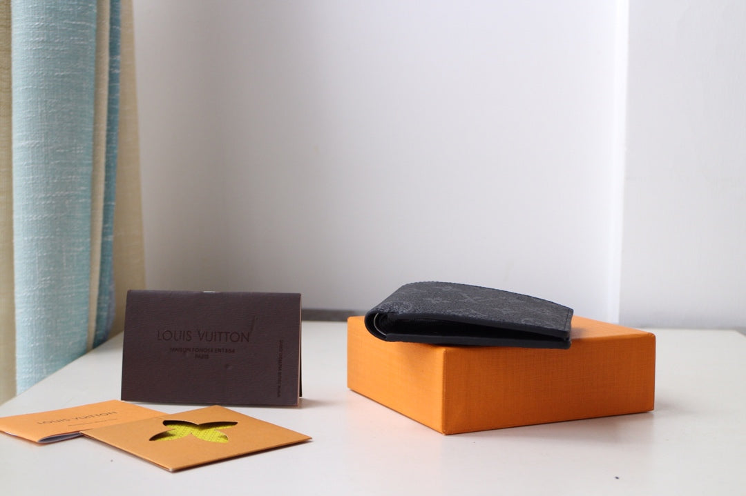 Louis Vuitton small bag, black leather pouch with dark strap