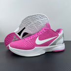 Pink low-top sneaker with white outsole and heel, textured sole tread, side swoosh