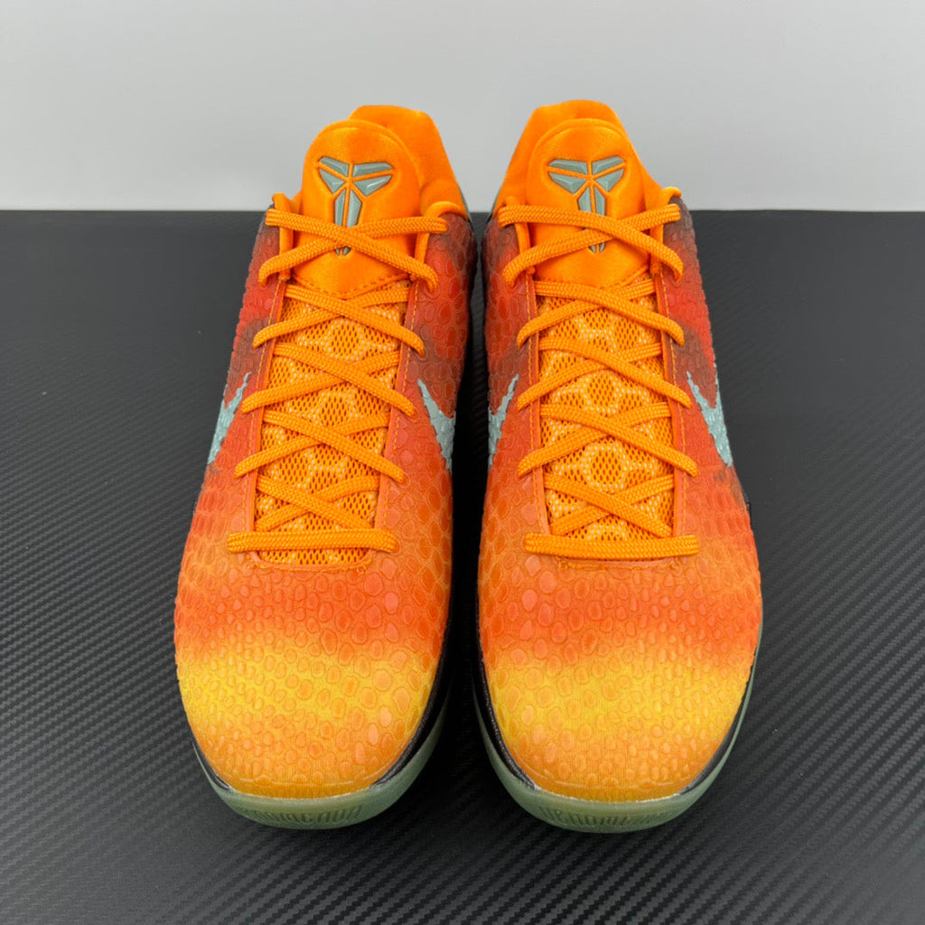 Pair of orange basketball shoes with orange laces and textured toe
