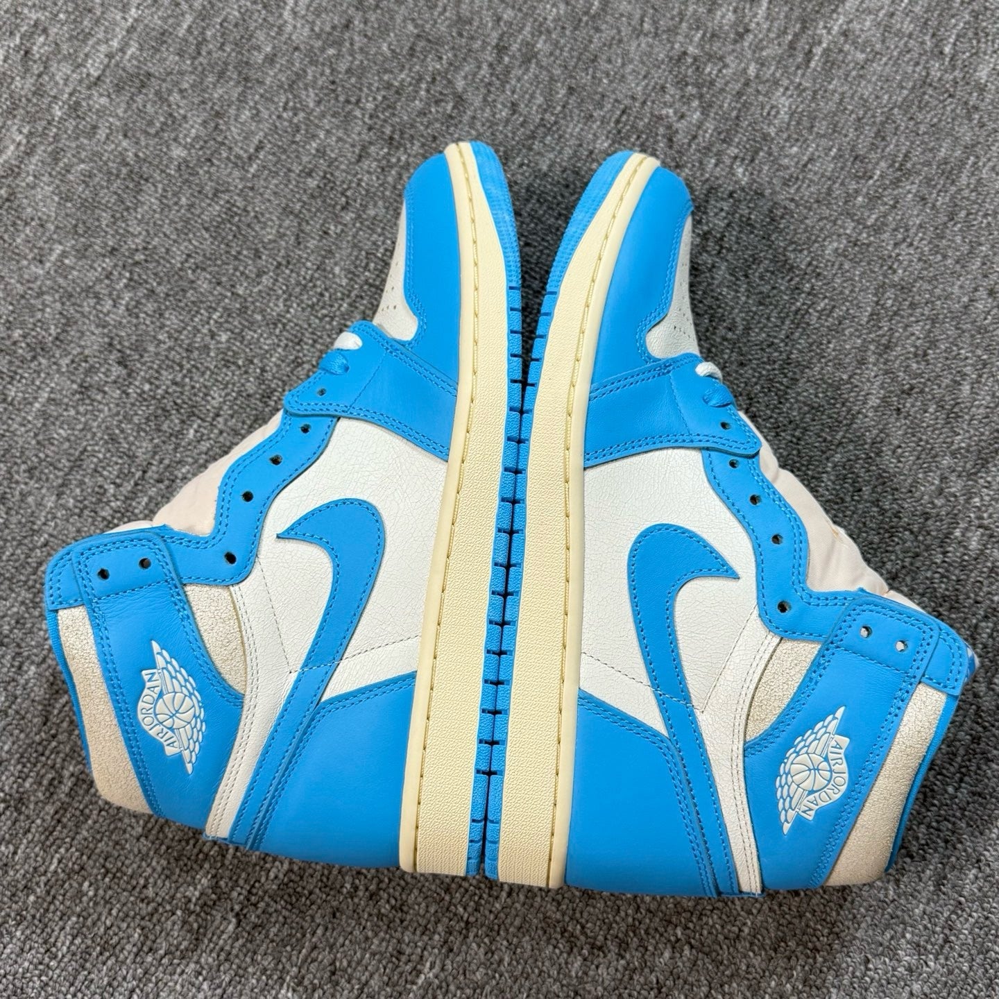 Air Jordan 1 Retro High OG sneakers, white and blue panels with ankle collar logo