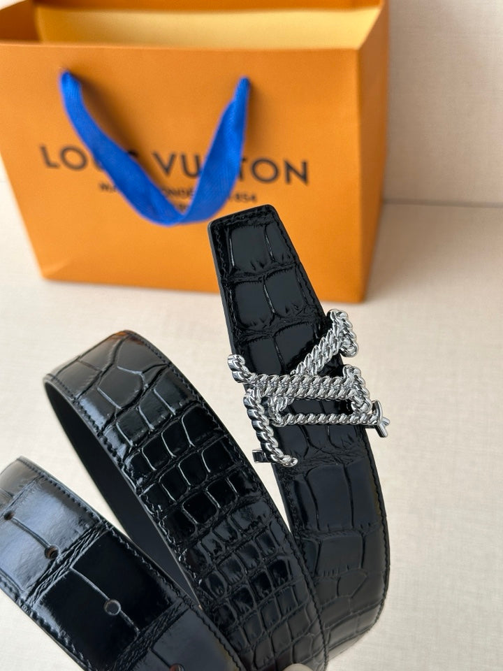 Dark blue croc-embossed leather belt with gold-tone LV buckle, close-up
