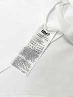 White T-shirt with attached fabric care label at side seam