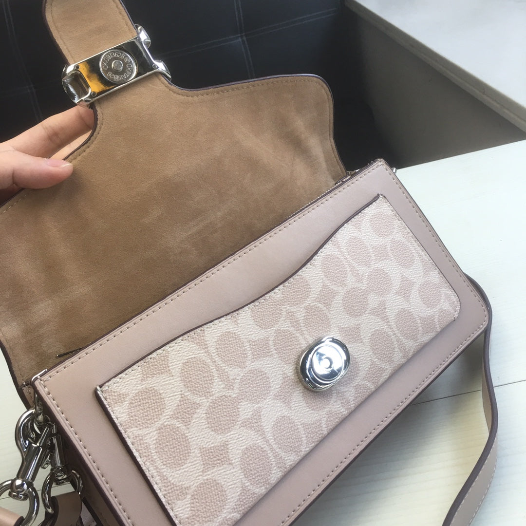 Coah bag front close-up with taupe flap, logo panel, and silver snap