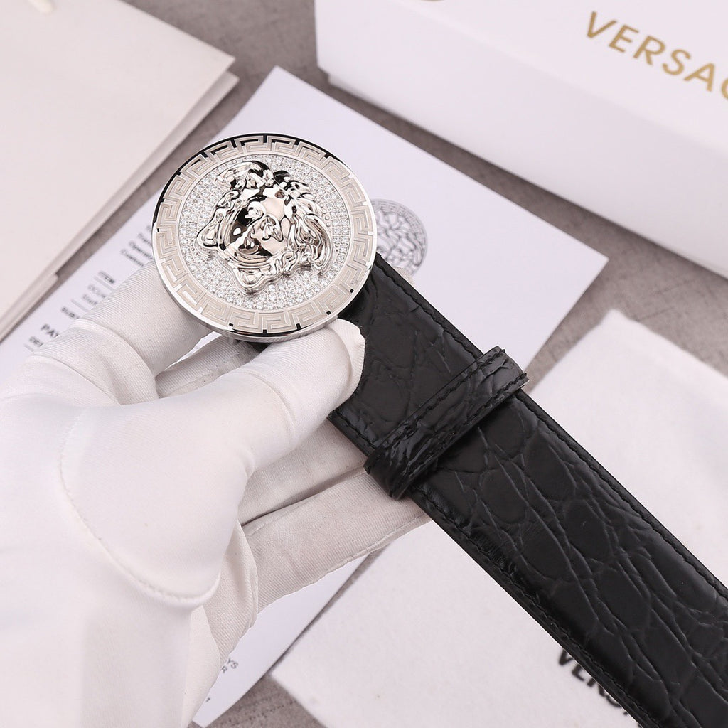 Versace belt close-up with black embossed leather strap and silver round Medusa buckle