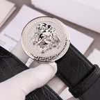 Versace belt detail: silver round Medusa buckle on black crocodile-embossed leather strap