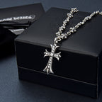 Silver-tone cross pendant necklace with rhinestone details and flower link chain