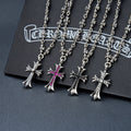 Silver-tone cross pendant necklace with floral charms and purple gem accents
