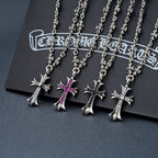 Silver-tone cross pendant necklace with floral charms and purple gem accents