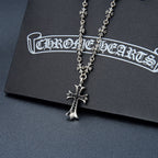 Silver-tone cross pendant necklace with flower charms and dark purple gem center