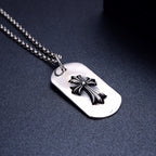 Dog tag pendant necklace close-up with silver flower on white oval tag