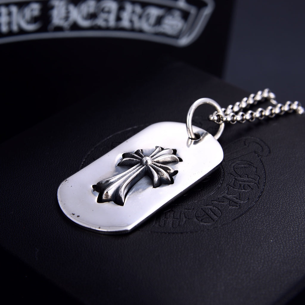 Dog tag pendant necklace with silver flower on white oval tag