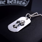 Dog tag pendant necklace with silver flower on white oval tag