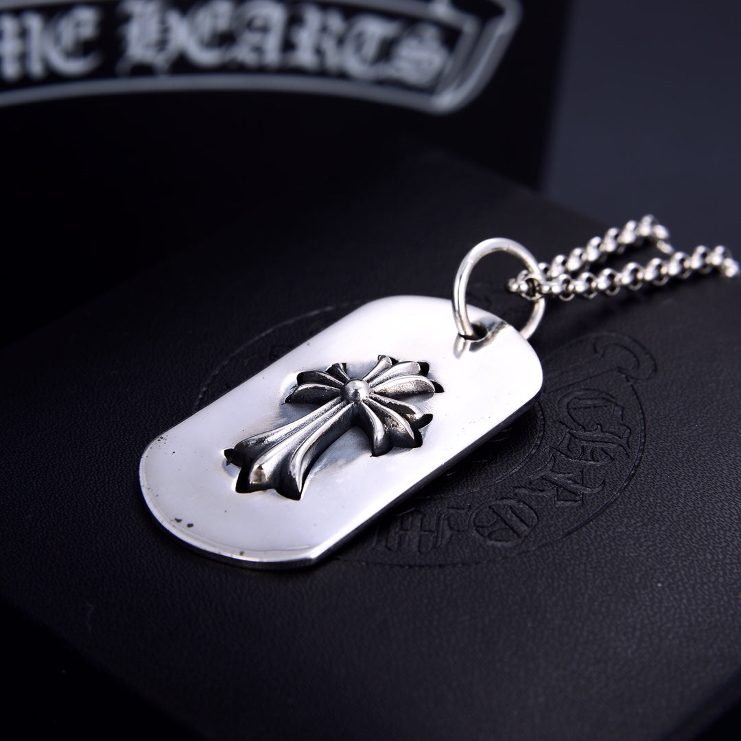 Dog tag pendant necklace with silver flower on white oval tag