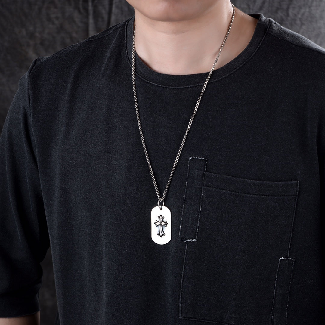 Dog tag pendant necklace with white oval tag and silver flower on chain