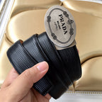 Prada belt strap roll with black ribbed texture and oval Prada Milano logo label