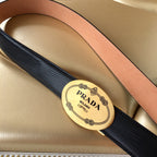 Prada belt detail: black textured strap with tan leather center stripe and gold logo buckle.