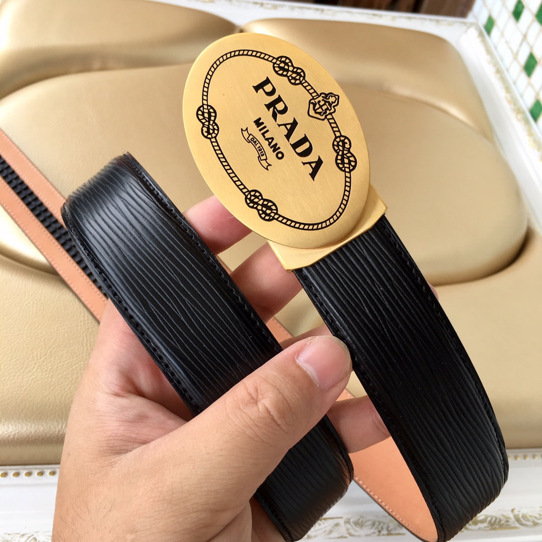Prada belt view: black textured strap and tan leather side with gold oval Prada Milano buckle.