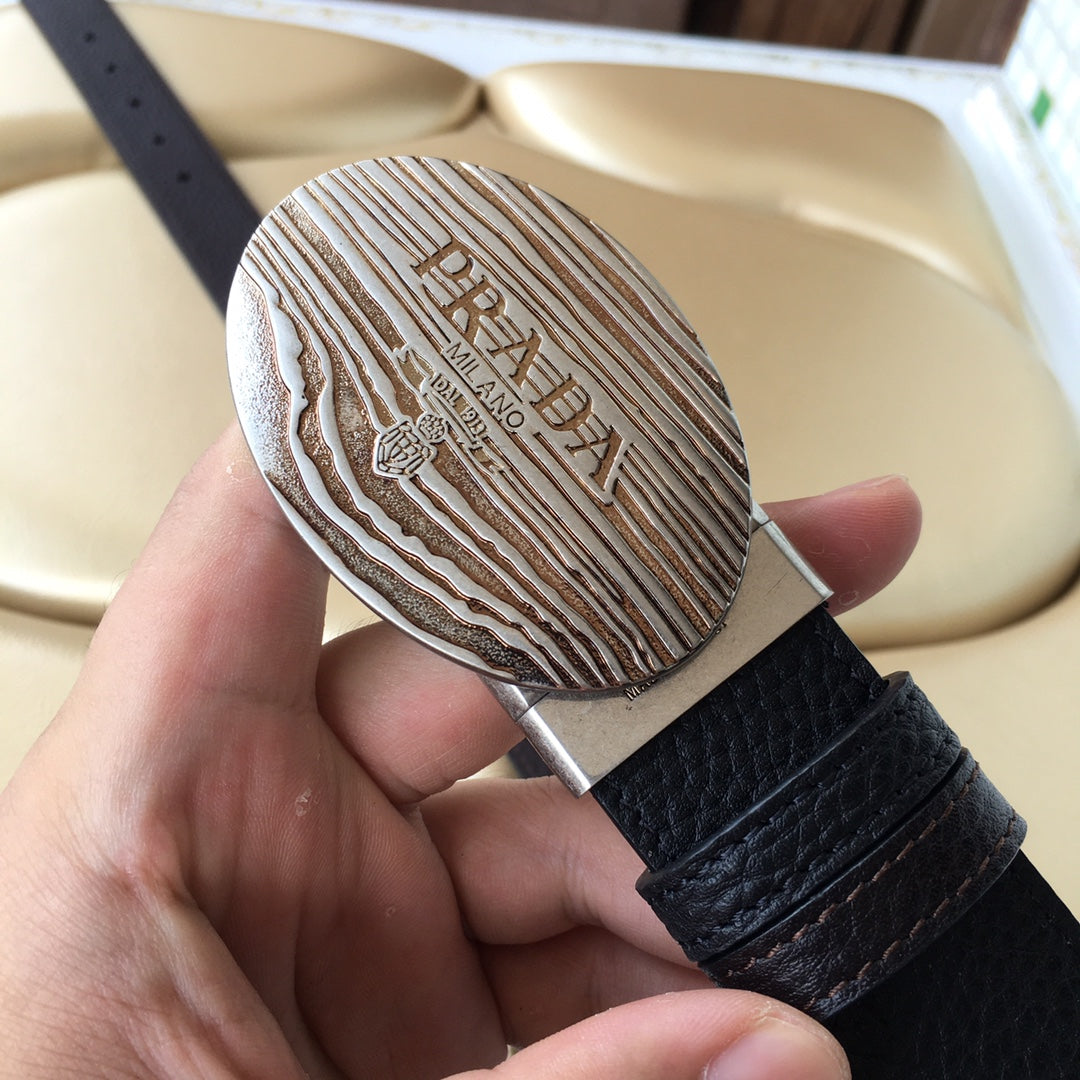 Prada belt with oval silver logo buckle and dark textured strap with hole section
