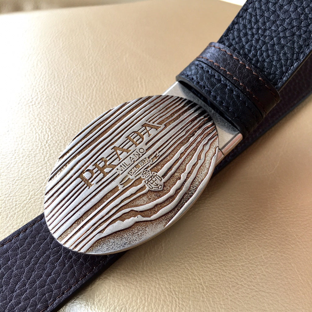 Prada belt oval silver logo buckle with engraved text on dark textured leather