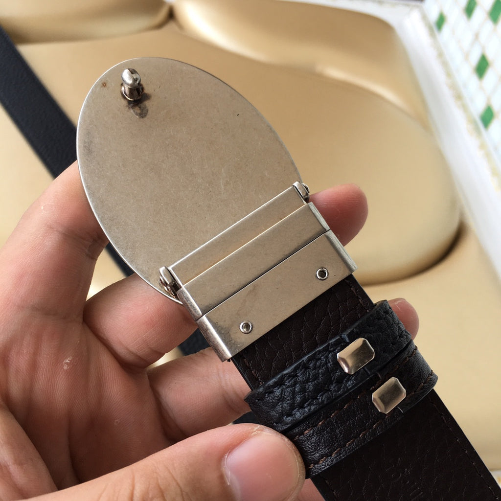 Prada belt back view with silver buckle frame, pin bar, and adjustable holes