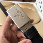 Prada leather belt with silver logo buckle and dark textured strap