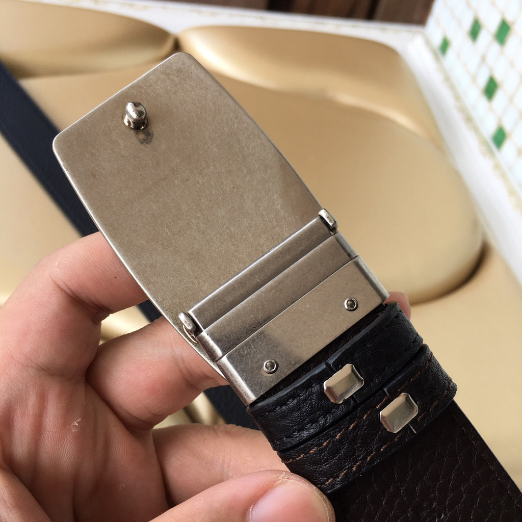 Prada belt buckle detail with silver clasp and dark grained leather strap