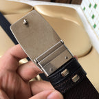 Prada belt buckle detail with silver clasp and dark grained leather strap