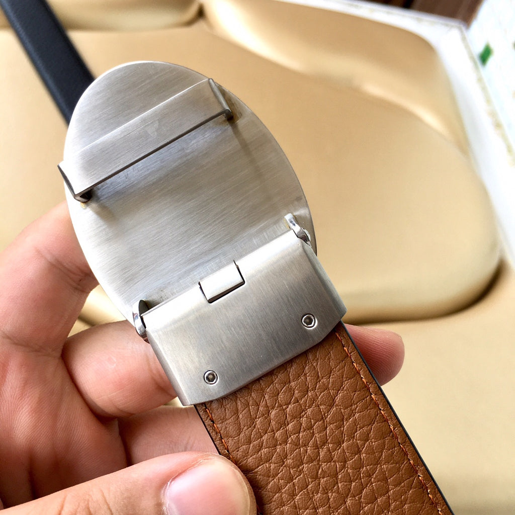 Leather belt with silver-tone buckle and metal pin, tan/brown strap