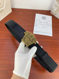 Black embossed belt with gold Medusa-style buckle and pin closure.