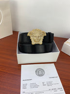 Black belt with gold emblem buckle in a white shoe-box-style holder