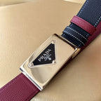 Prada belt detail: silver buckle with Prada logo, black strap and burgundy leather edge.
